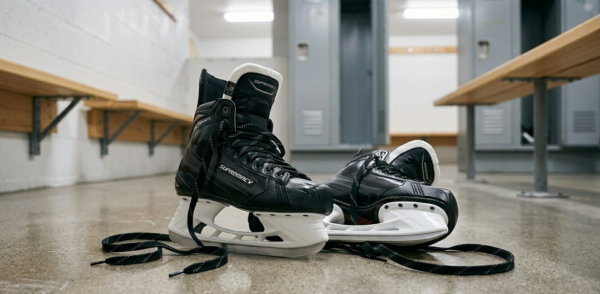 wet hockey skates on locker room floor after a game